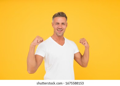 Strength And Power. Happy Bachelor Show Strength. Strong Man Flex Arms Yellow Background. Strength And Confident. Strength Comes From Within.