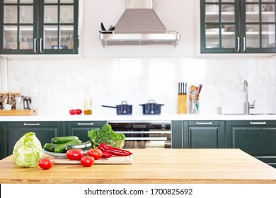 strengthening immunity during the coronavirus pandemic. Fresh vegetables on the table on a background of green kitchen. Kale cabbage, tomatoes, zucchini, cucumbers, paprika,  cabbage. Avitaminosis.  - Powered by Shutterstock