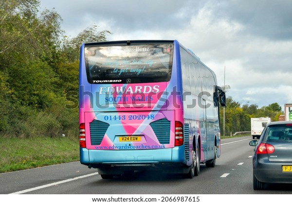 Strensham, England - October 2021: Tour bus\
operated by South Wales coach holiday company Edwards Travel\
driving on the M5\
motorway