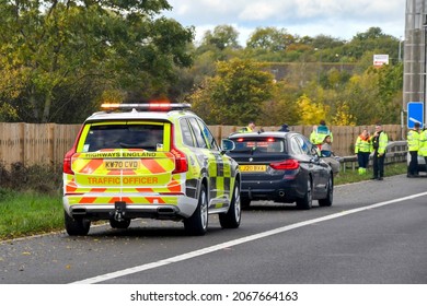 Strensham, England - October 2021: Traffic Office Patrol Car Parked On The Hard Shoulder Of The M5 Motorway With Flashing Lights To Warn Of An Accicdent