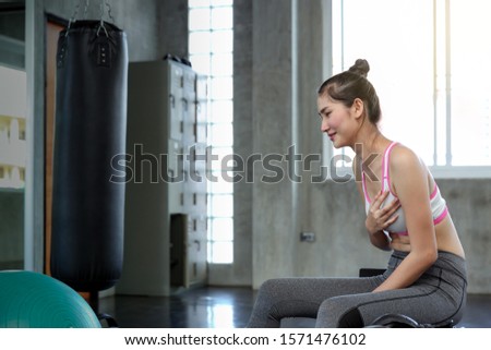 Strenuous exercise can endanger life Women suffering from chest pain. Female touching her chest with hands while exercise. Asian girl. Beautiful women in sportswear are touching her chest feeling pai