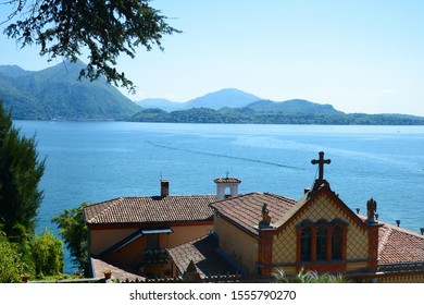 Stresa, Italy - 01 May 2019 Borromeo House, Details Of The Facade Family Chapel, With Beautiful Decorations Made With Terracotta Panels. On The Background The Lake Maggiore.