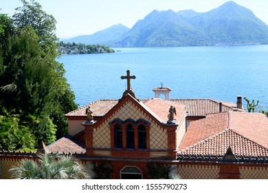 Stresa, Italy - 01 May 2019 Borromeo House, Details Of The Facade Family Chapel, With Beautiful Decorations Made With Terracotta Panels. On The Background The Lake Maggiore.