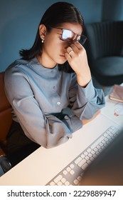 Stress, anxiety and burnout with a business woman at work on a computer at a desk in her office from above. Compliance, mental health and headache with a female employee struggling to make a deadline - Shutterstock ID 2229889947