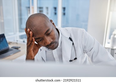 Stress, Anxiety And Sad Doctor At Work On Computer, Sick And Headache In A Hospital Or Clinic. Medical Professional Or Healthcare Worker In Depression, Burnout And Working And Thinking About Health.