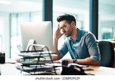 Stress, anxiety and worry with a business man feeling frustrated, irritated and annoyed with work and deadlines. Unhappy and negative male employee suffering from a headache or migraine  - Shutterstock ID 2188929529