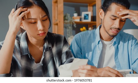 Stress Asia Couple Man And Woman Use Calculator For Calculate Family Budget, Debts, Monthly Expenses During Financial Economic Crisis At Home. Marriage Money Trouble, Family Budget Planning Concept.