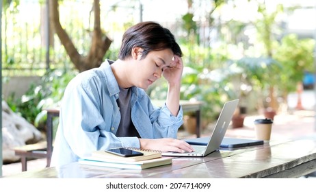 Stress Asian Man Struggle With Laptop Computer, Frustrated Male At Home Office Desk, People Struggle With Technology, Asia Male Overworked, Exhausted And Take A Break While Work From Home