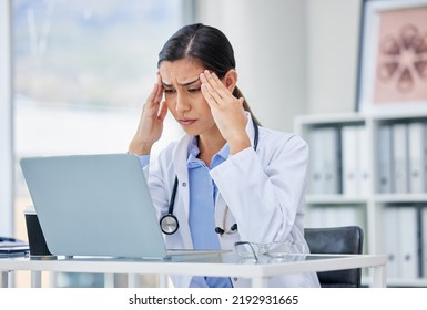 Stress Or Burnout With Doctor Thinking And Working On Laptop In Hospital Consulting Room Or Office. Medical Healthcare Worker Or Specialist Surgeon With Anxiety Headache From Mental Health Issues