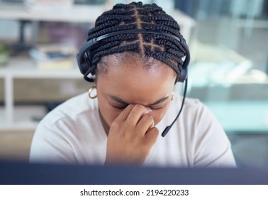 Stress, Burnout And Sad Call Center Agent With A Headache And Office Overworked Sitting In An Office. Frustrated, Sick Or Ill Young Black Woman Customer Service Employee With Pain Or Migraine