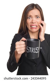 Stress concept. Business woman stressed being too busy. Businesswoman in suit holding head drinking coffee creating more stress. Mixed race Asian Caucasian female isolated on white background.