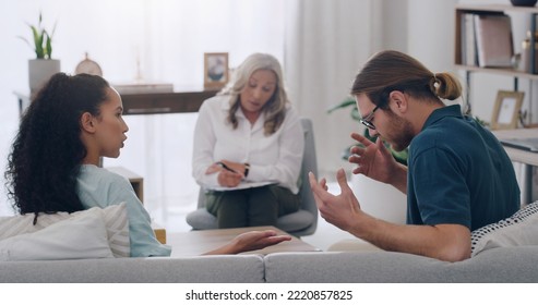 Stress, Divorce And Couple In Counseling With Psychologist Listening To Fighting, Marriage Problems And Conflict. Psychology, Trouble And Therapist Helping A Young Woman And Angry Partner In Therapy