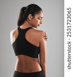 Stress, fitness or girl in studio with shoulder pain, physical strain or massage for tension relief. Woman, sports injury or discomfort on gray background with crisis, accident or mistake in activity