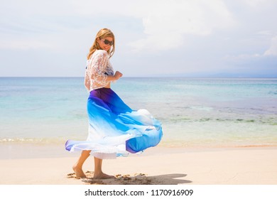 Stress Free Woman Dancing On The Beach