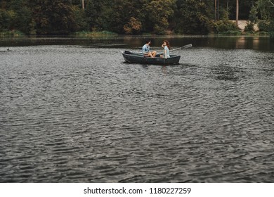 Stress Free Zone. Beautiful Young Couple Having Romantic Date While Rowing A Boat