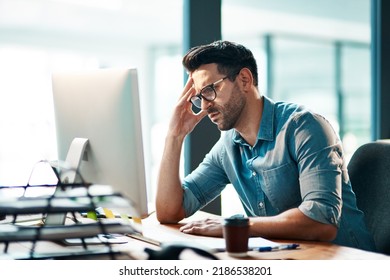 Stress, headache and frustrated business man working on computer in an office, annoyed and anxious. Male under pressure from a workload and deadline. Depressed guy experiencing burnout at work - Powered by Shutterstock