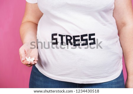 stress, mind problems, bulimia, compulsive overeating, weight gain. overweight woman with sedative pills