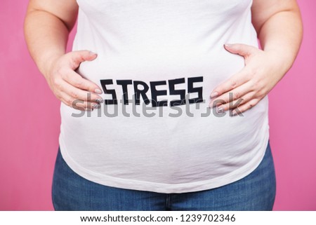 stress, mind problems, bulimia, compulsive overeating, weight gain. overweight woman with belly fat, close up