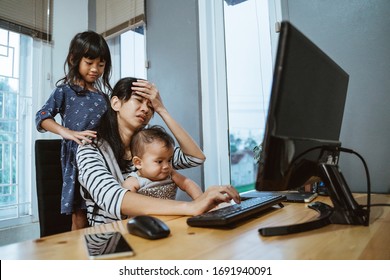 stress mother while working from home and babysitting her children