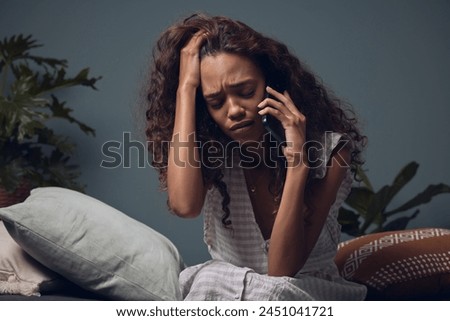 Stress, phone call and woman on sofa with crying for break up, grief and loss in home. Mental health, divorce and girl with depression, smartphone and telehealth for discussion with helpline support.