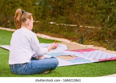 Stress Relief With Art Therapy. Teenager Girl Paints A Paper House Template With Colorful Watercolors In The Garden. Kid Being Homeschooled Due To School Shut Down During Corona Virus Pandemic.