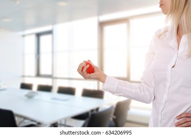 Stress relief concept. Worried and upset business woman trying to calm down with anti stress rubber ball in an office. - Powered by Shutterstock