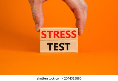 Stress Test Symbol. Concept Words Stress Test On Wooden Blocks On A Beautiful Orange Background. Businessman Hand. Business And Stress Test Concept, Copy Space.