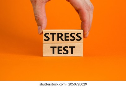 Stress Test Symbol. Concept Words Stress Test On Wooden Blocks On A Beautiful Orange Background. Businessman Hand. Business And Stress Test Concept, Copy Space.