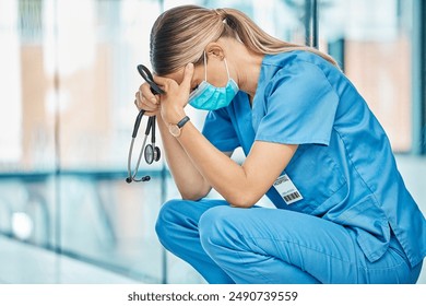 Stress, tired nurse and woman in hospital with depression, burnout or anxiety for mistake. Sad, surgery fail and medical worker with grief, fatigue or headache in healthcare clinic with stethoscope - Powered by Shutterstock