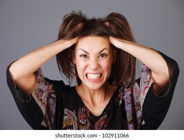 Stress. Woman stressed is going crazy pulling her hair in frustration.