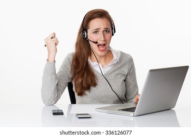 Stress At Work Concept - Nervous Young Female Manager Working In Pure Office Environment, Communicating About Bad Sales On Headset And Computer, Studio Shot,white Background