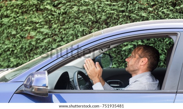 Stressed and annoyed male driver on the road during\
the rush hour