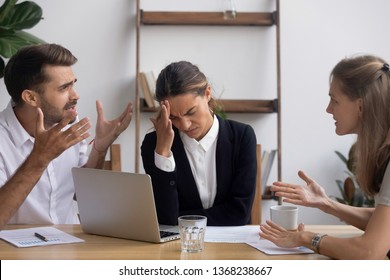 Stressed annoyed office employee manager having headache migraine at business meeting with complaining client customer tired of angry colleagues arguing shouting having conflict dispute at workplace - Powered by Shutterstock