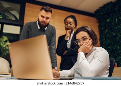 Stressed annoyed office employee manager having headache migraine at business meeting with his colleagues about business problem they have to solve. Multiracial team. - Powered by Shutterstock