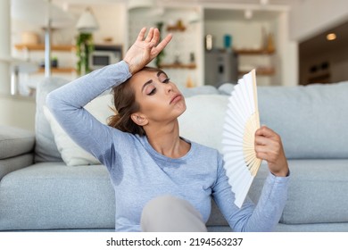 Stressed Annoyed Woman Using Waving Fan Suffer From Overheating, Summer Heat Health Hormone Problem, No Air Conditioner At Home Sit On Sofa Feel Exhaustion Dehydration Heatstroke Concept