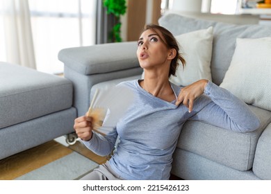 Stressed Annoyed Woman Using Waving Fan Suffer From Overheating, Summer Heat Health Hormone Problem, No Air Conditioner At Home Sit On Sofa Feel Exhaustion Dehydration Heatstroke Concept