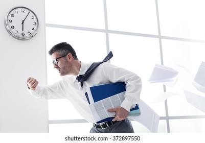 Stressed anxious businessman in a hurry checking time and running, he is late for his business appointment