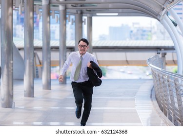 Stressed Anxious Businessman In A Hurry And Running, He Is Late For His Business Appointment And Wear A Shirt While Running.