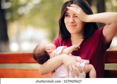 Stressed Anxious Mother Holding Newborn Daughter. Worried New Mom With Baby Girl In Her Arms
