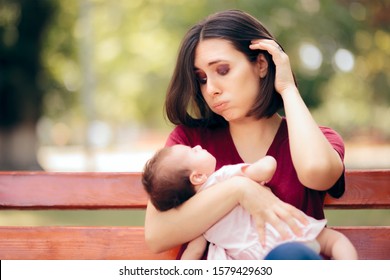 Stressed Anxious Mother Holding Newborn Daughter. Worried New Mom With Baby Girl In Her Arms
