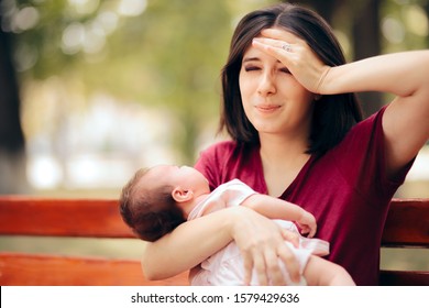 Stressed Anxious Mother Holding Newborn Daughter. Worried New Mom With Baby Girl In Her Arms
