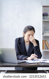 Stressed Asian Businesswoman With Headache Concept From Accounting Work In Front Of Laptop Women Are Tired Of Headaches Or Chronic Fatigue At Work. Office Syndrome Concept
