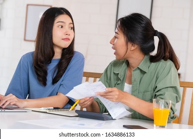 Stressed Asian Lesbian Couple Serious And Argument When Calculate Home Financial Bill Budget On Table In Kitchen At New House