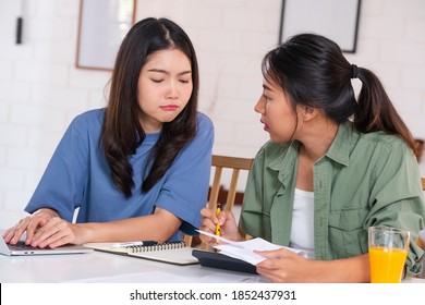 Stressed Asian Lesbian Couple Serious And Argument When Calculate Home Financial Bill Budget On Table In Kitchen At New House