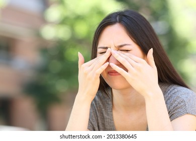 Stressed Asian Woman Scratching Itchy Eyes In The Street