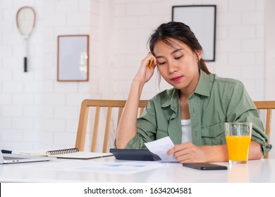 Stressed Asian Woman Serious And Argument When Calculate Home Financial Bill Budget On Table In Kitchen At New House