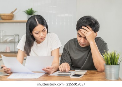 Stressed asian young couple family, wife and husband confused by calculate expense from invoice or bill, have no money to pay. Mortgage, loan causing debt, bankruptcy. Debt problems, Financial people. - Shutterstock ID 2155017057