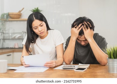 Stressed asian young couple family, wife and husband confused by calculate expense from invoice or bill, have no money to pay. Mortgage, loan causing debt, bankruptcy. Debt problems, Financial people. - Shutterstock ID 2162731995