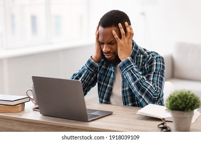 Stressed Black Businessman Having Headache Sitting At Laptop Having Problem At Workplace In Modern Office. Crisis And Unemployment, Entrepreneurship Business Issues, Migraine And Stressful Work Life - Shutterstock ID 1918039109