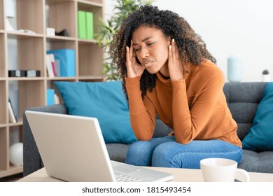 Stressed black woman working on computer